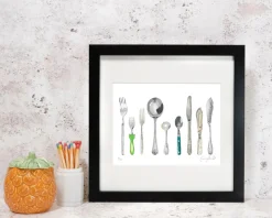 Corinne Alexander A Handful of Cutlery Framed Print by- Art